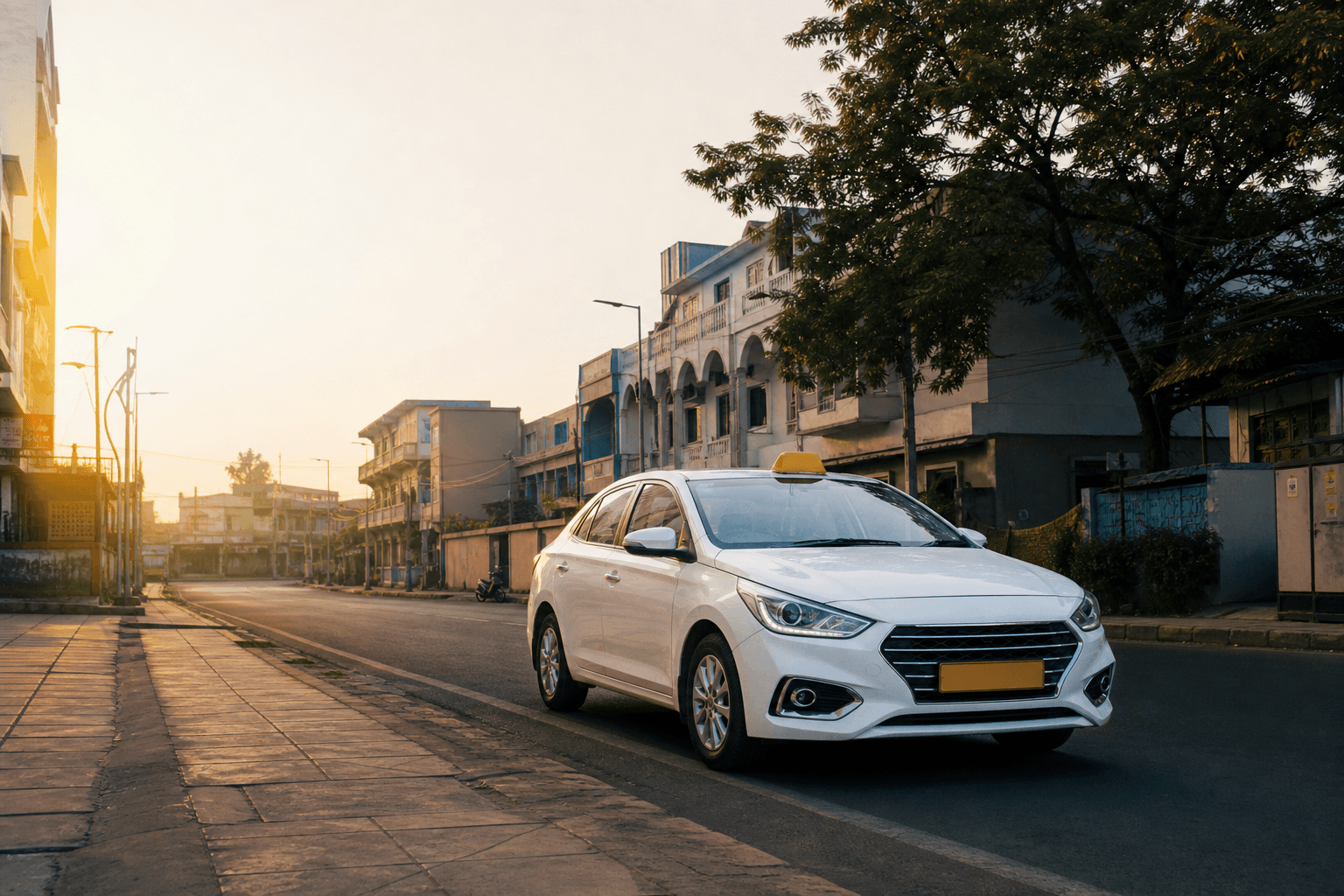 Clean white Rathya taxi on a quiet Gaya city street at golden hour